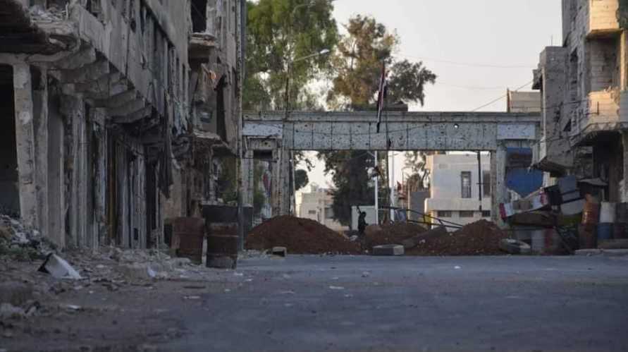an earthen berm erected by the government forces in a street in one of the neighborhoods of the city of Daraa (al-Balad), southern Syria