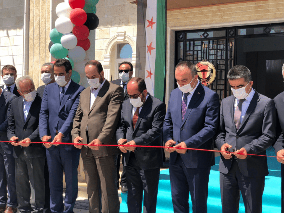 Naser al-Hariri, the then-President of the Syrian National Coalition (SNC) (center, in brown suit) and the President of the Syrian Interim Government (SIG) (center, in red tie) inaugurate the local council building in the northern Aleppo countryside city f al-Rai, 25/8/2020 (Syrian Interim Government)