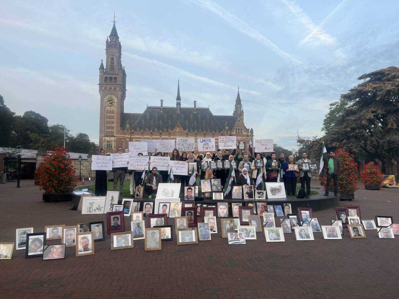 Torture survivors, activists and family members of some of Syria’s thousands of forcibly disappeared people rallied outside the Peace Palace in The Hague on Tuesday morning as the International Court of Justice heard oral arguments by Canada and the Netherlands in a landmark case against Syria for state-sponsored torture, 10/10/2023 (Caesar Families Association/Yasmin Mashaan)