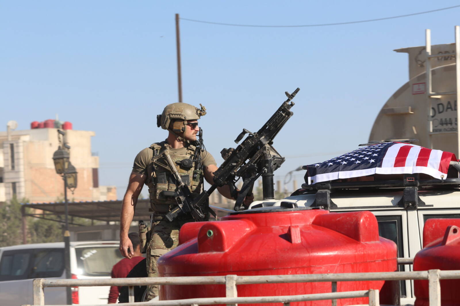 An American soldier stands on a vehicle belonging to United States (US) forces in the Tal Hajar neighborhood of Syria’s northeastern Hasakah city, July 2023 (Salam Ali/Syria Direct)