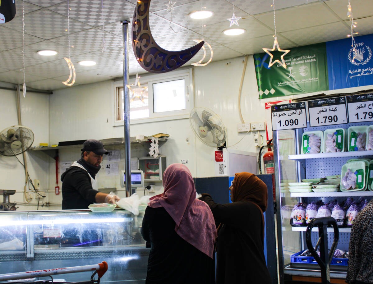 Syrian women buy meat at Safeway supermarket in Jordan’s Zaatari refugee camp, 3/4/2024 (Hanna Davis/ Syria Direct)