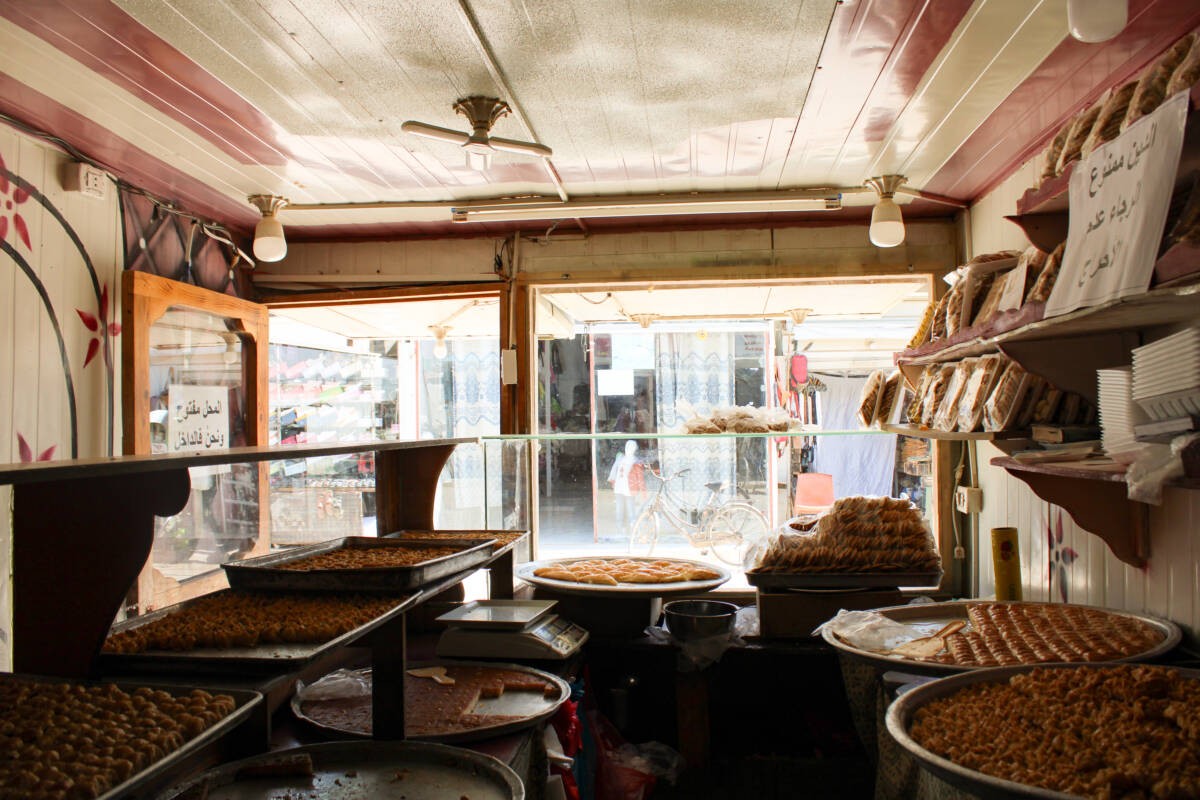 A sweets shop on Zaatari camp’s bustling Sham Elysées street, 3/4/2024 (Hanna Davis/ Syria Direct)