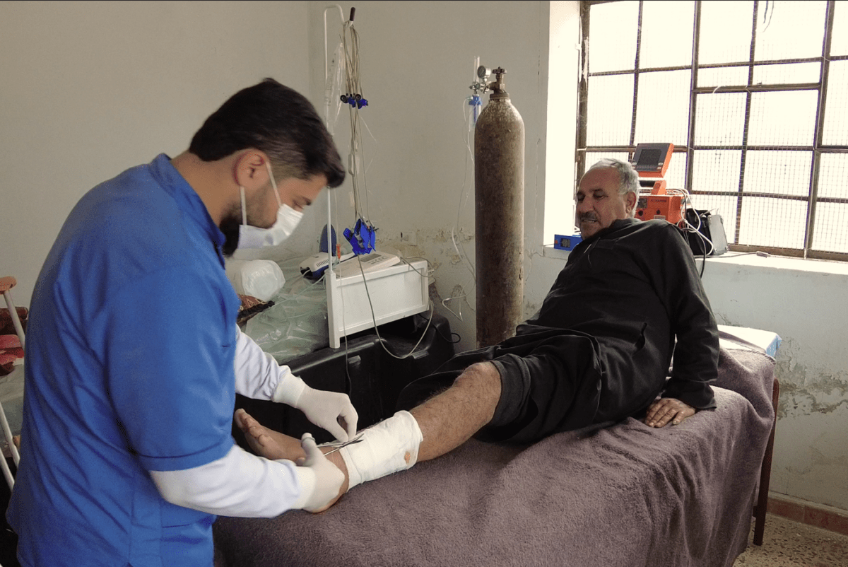 Farmer Anwar al-Halabi, 63, visits a health center in the Idlib countryside village of al-Laj to treat an injury he received when he was targeted by a suicide drone in March, 10/5/2024 (Abdul Razzaq al-Shami/Syria Direct)